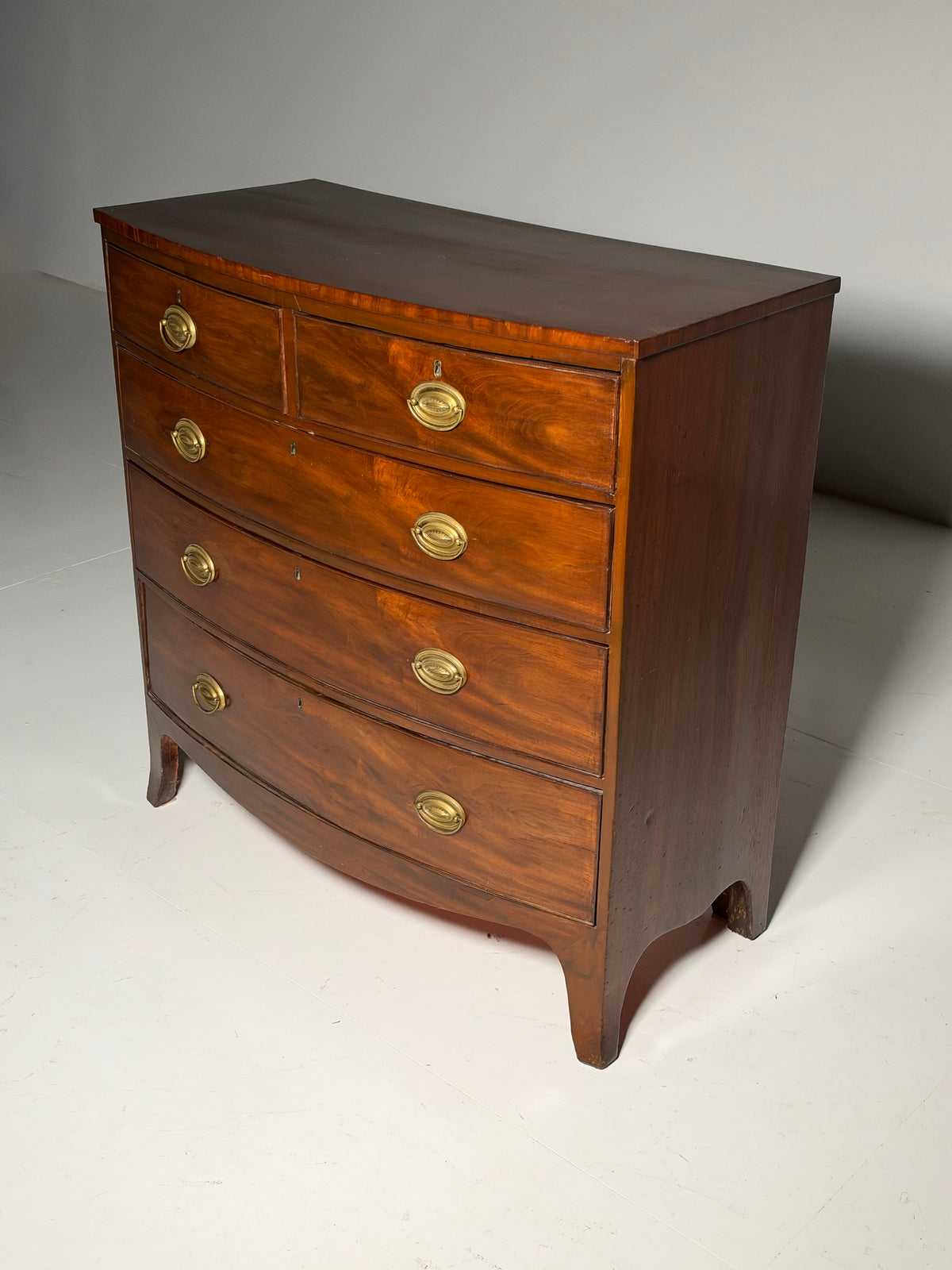 English bow-front chest of drawers in mahogany