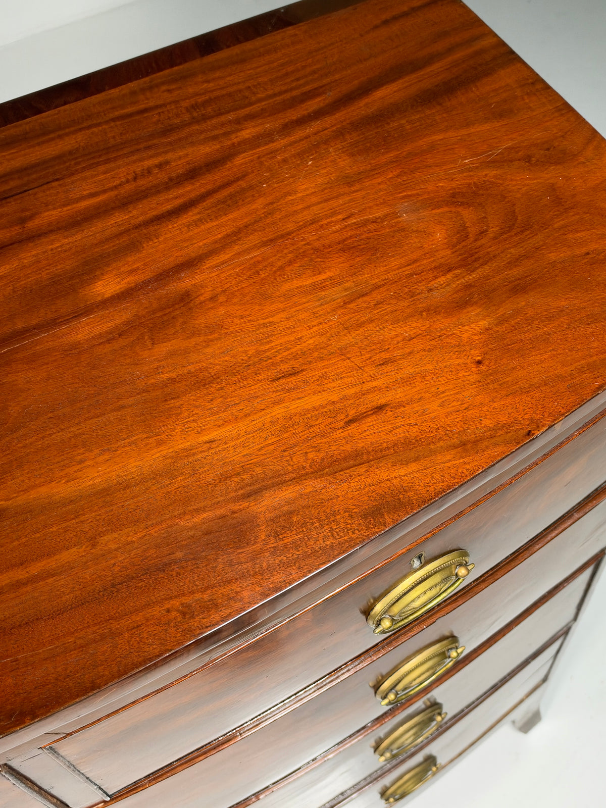 English bow-front chest of drawers in mahogany