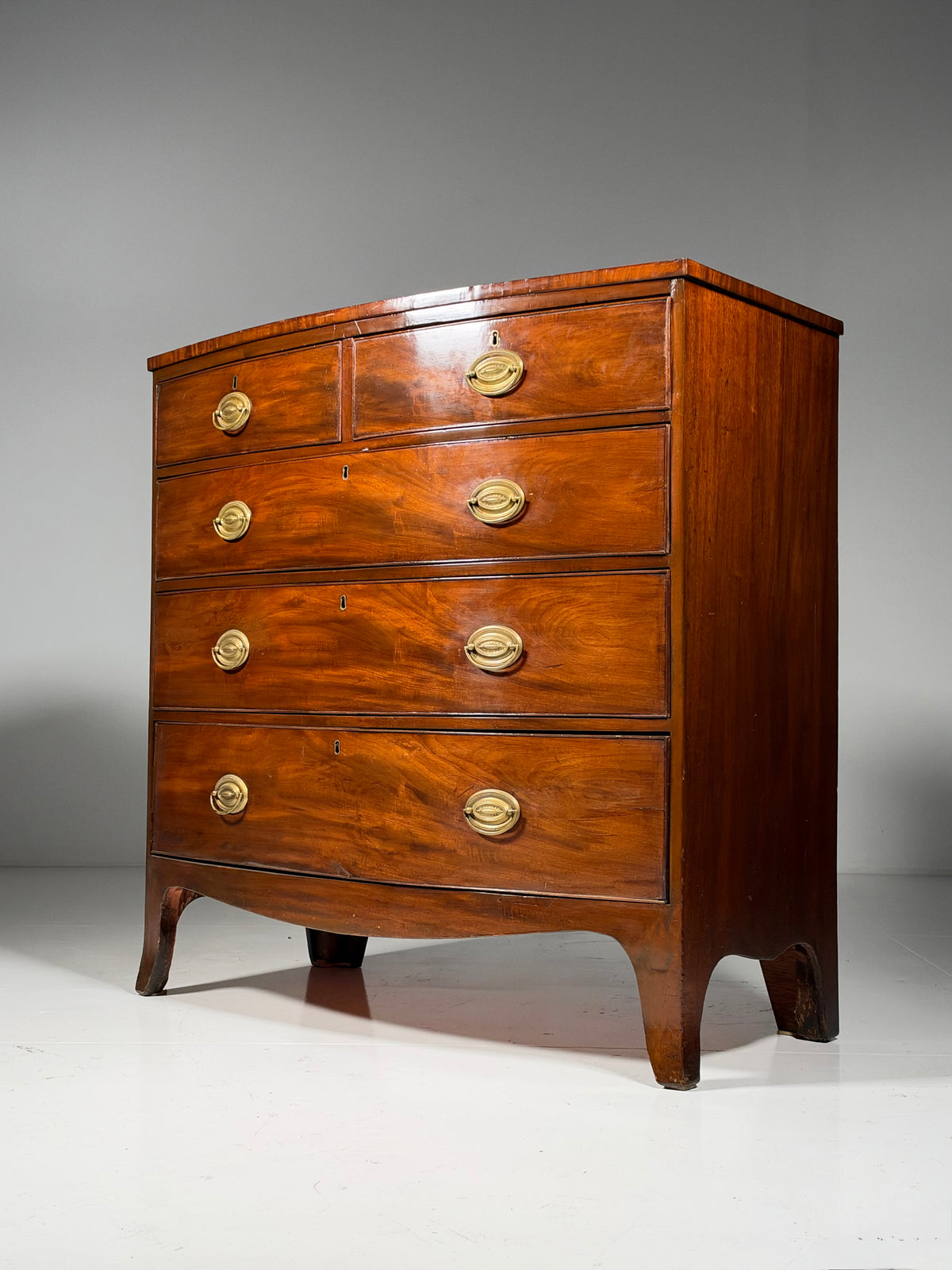 English bow-front chest of drawers in mahogany