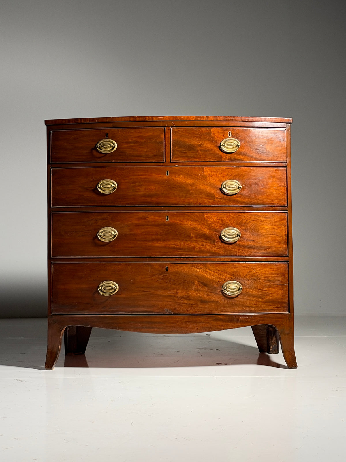 English bow-front chest of drawers in mahogany