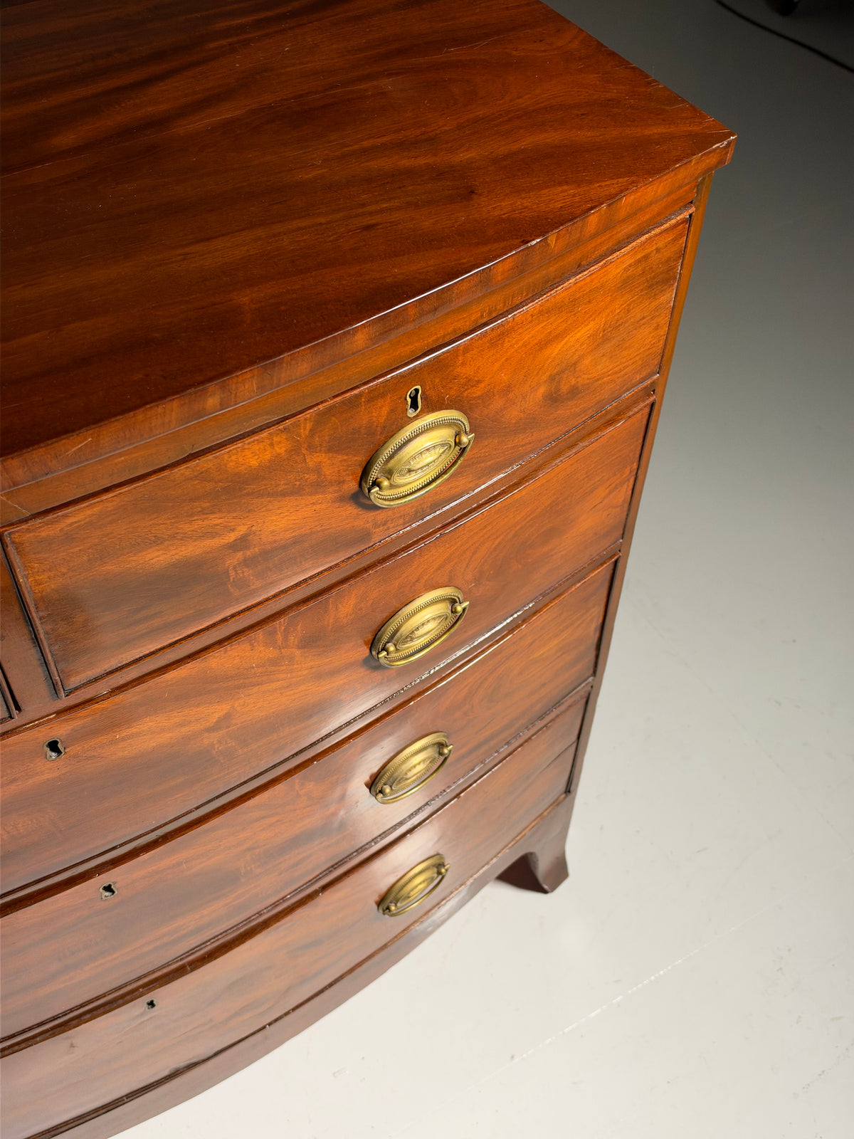 English bow-front chest of drawers in mahogany