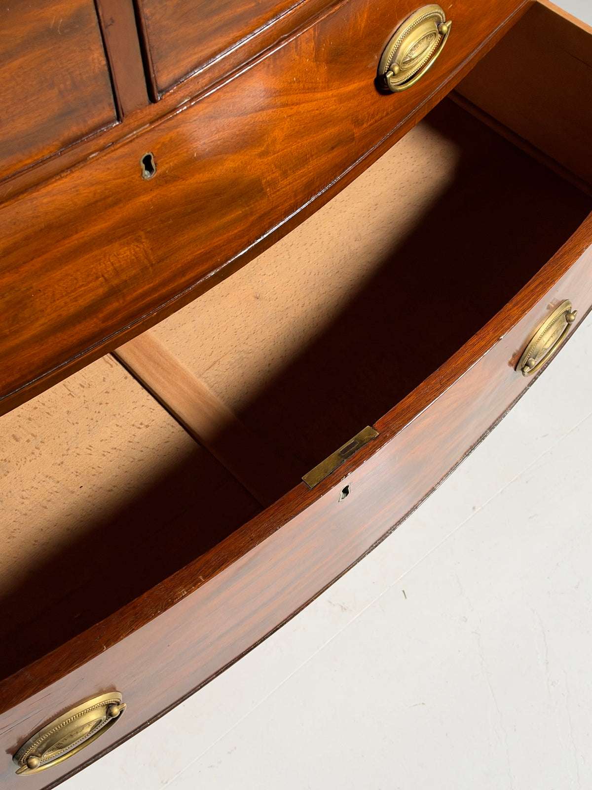 English bow-front chest of drawers in mahogany