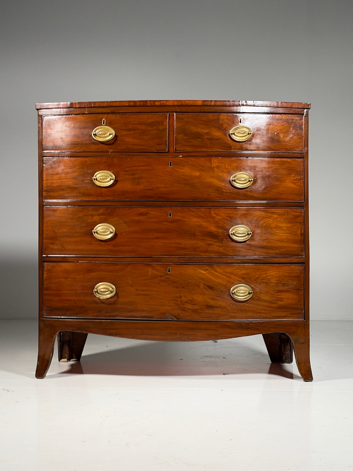 English bow-front chest of drawers in mahogany